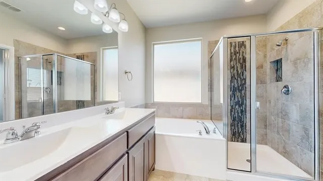 a bathroom with a bathtub shower sink and mirror