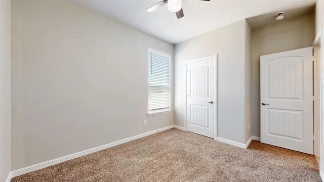 an empty room with windows and closet