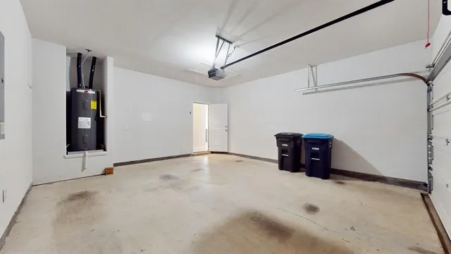 an empty room with windows and ceiling fan