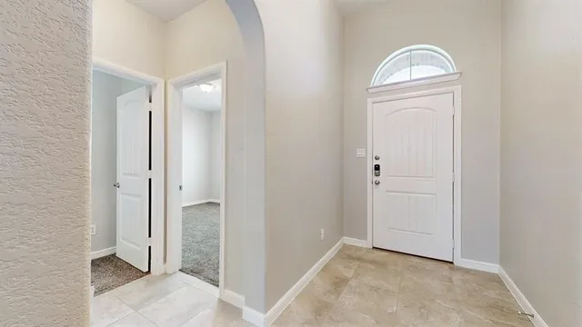 an empty room with closet mirror and window