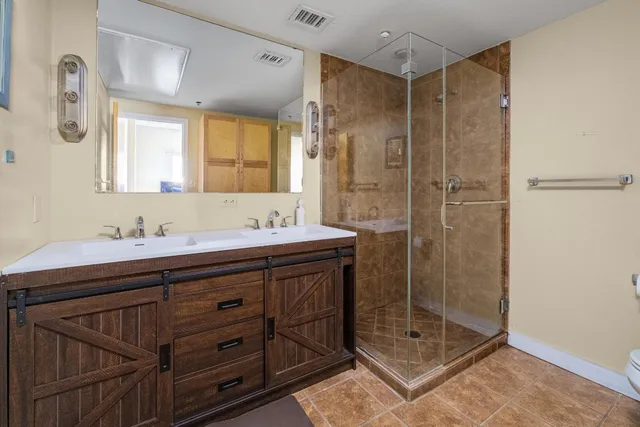 a bathroom with a shower sink and mirror