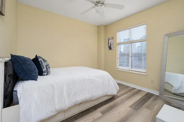 a bedroom with a bed and a chandelier
