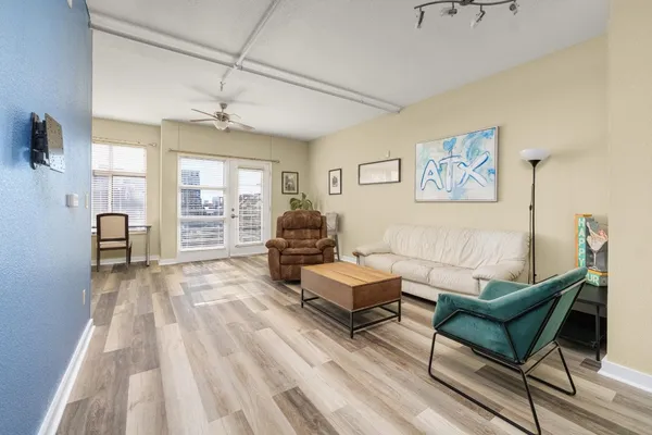 a living room with furniture and a wooden floor
