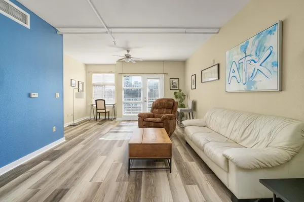 a living room with furniture and wooden floor