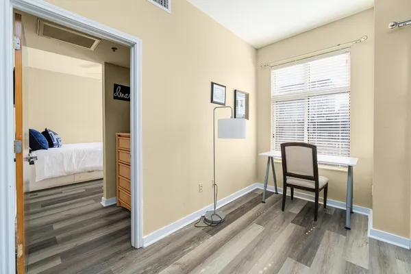 a view of a room with lounge chair windows and wooden floor