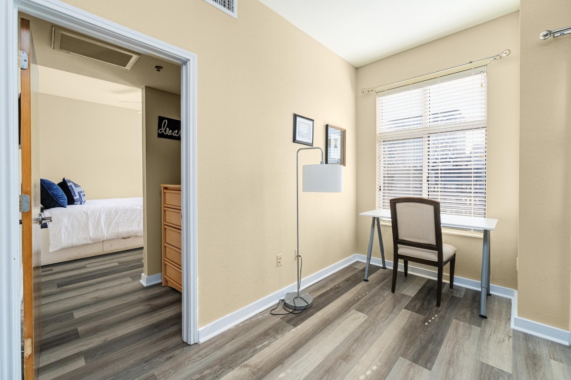 711 West 26th Street, Unit 706 Austin, TX 78705 - Photo 6 of 24 a view of a room with lounge chair windows and wooden floor