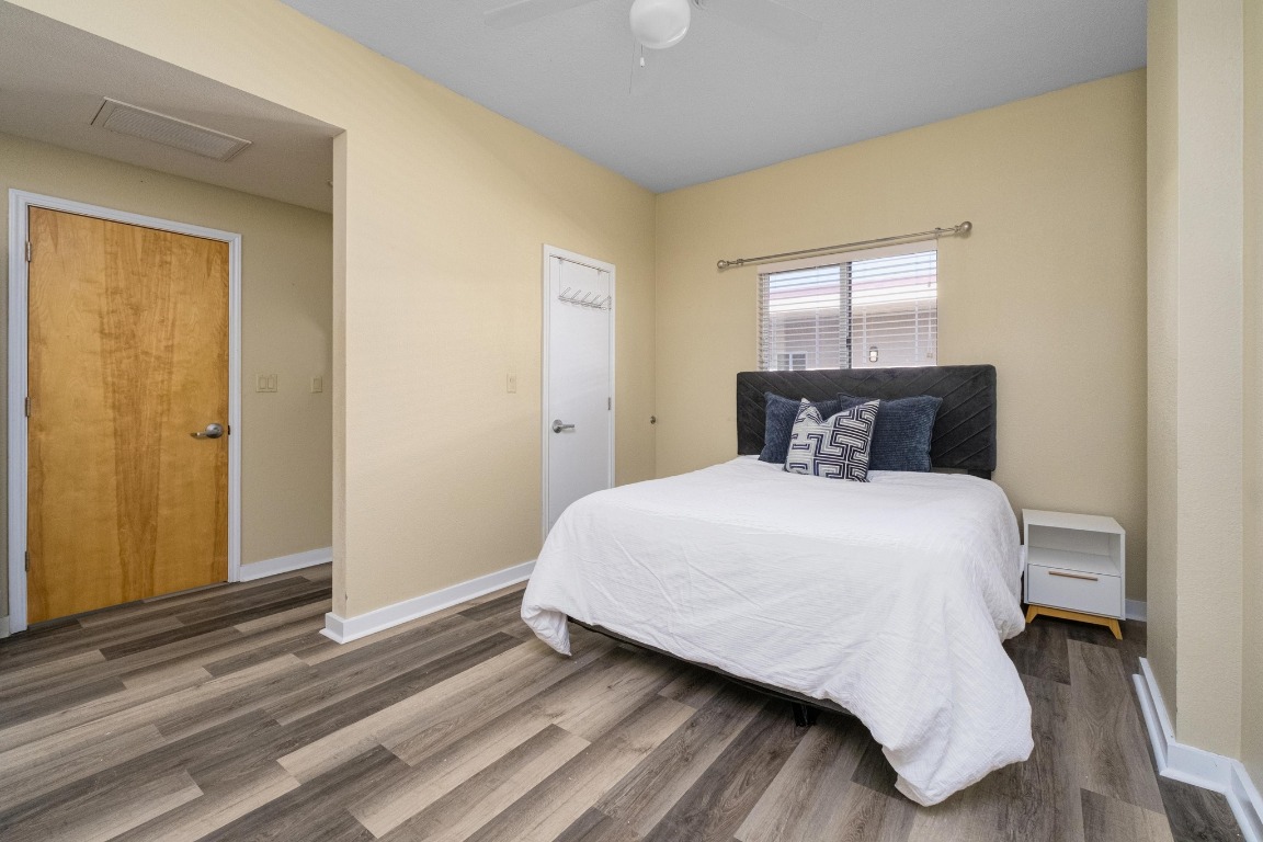 711 West 26th Street, Unit 706 Austin, TX 78705 - Photo 10 of 24 a bedroom with a bed and wooden floor