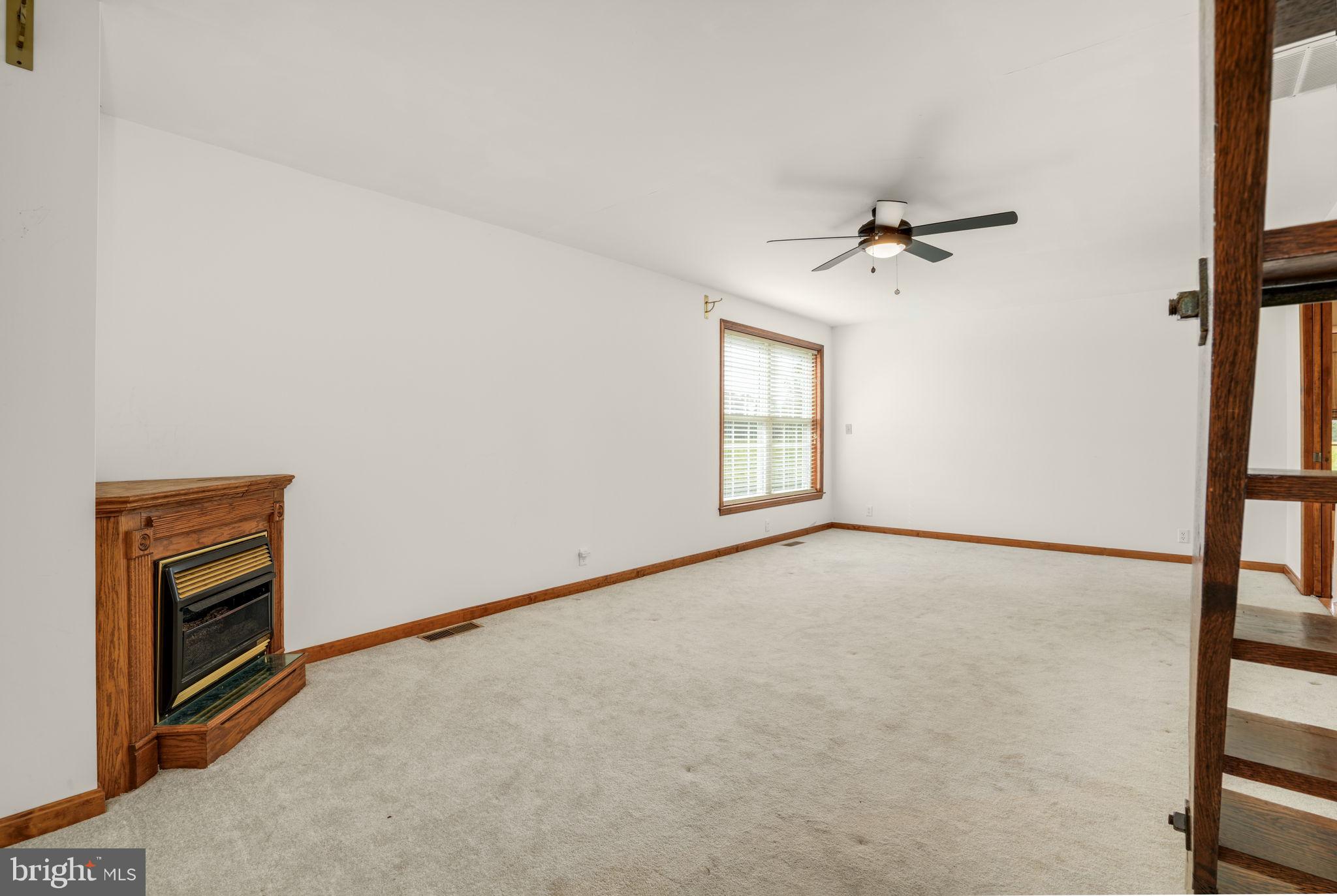 9449 Carey Road Berlin, MD 21811 - Photo 77 of 108 an empty room with windows and ceiling fan