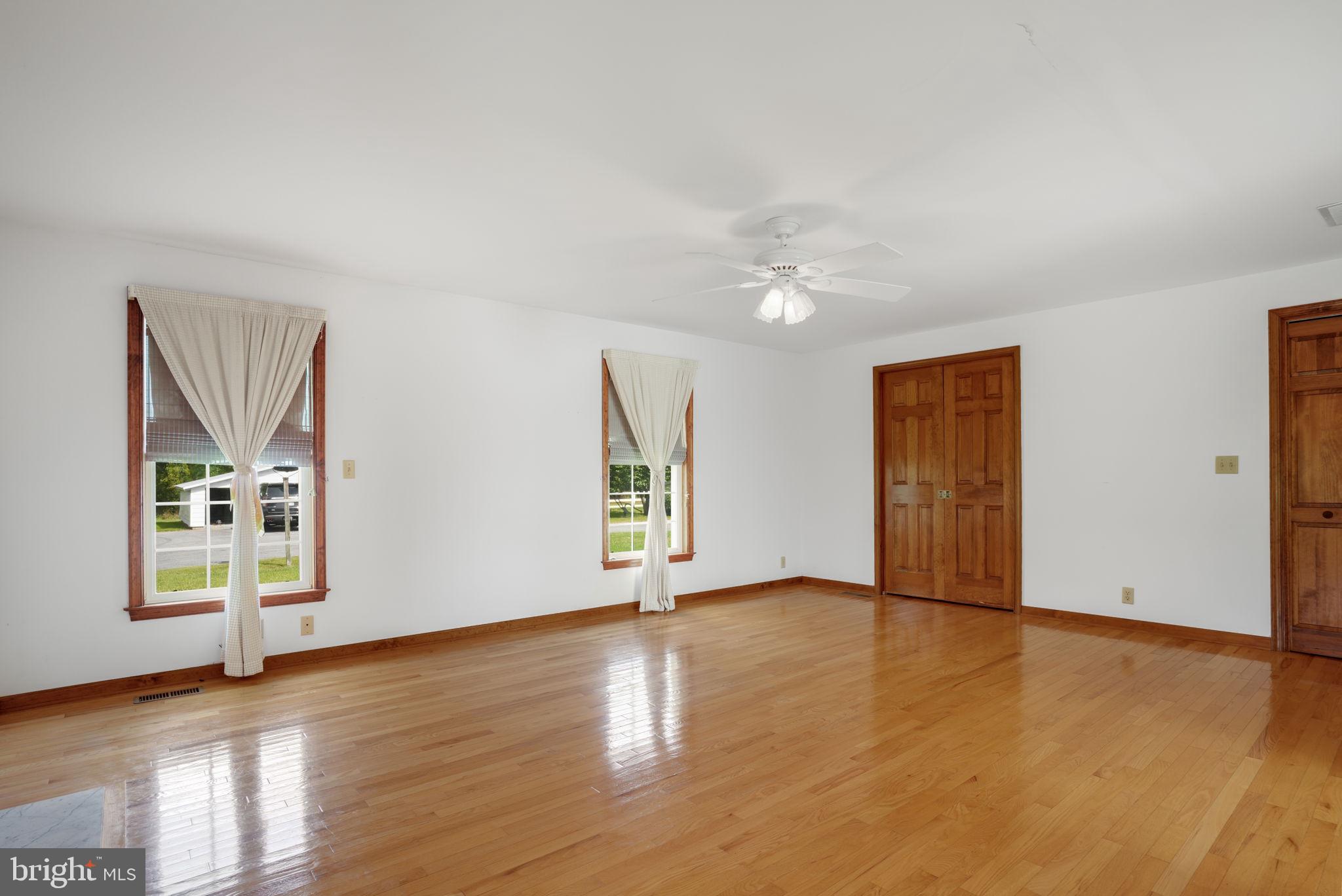 9449 Carey Road Berlin, MD 21811 - Photo 83 of 108 an empty room with wooden floor and windows