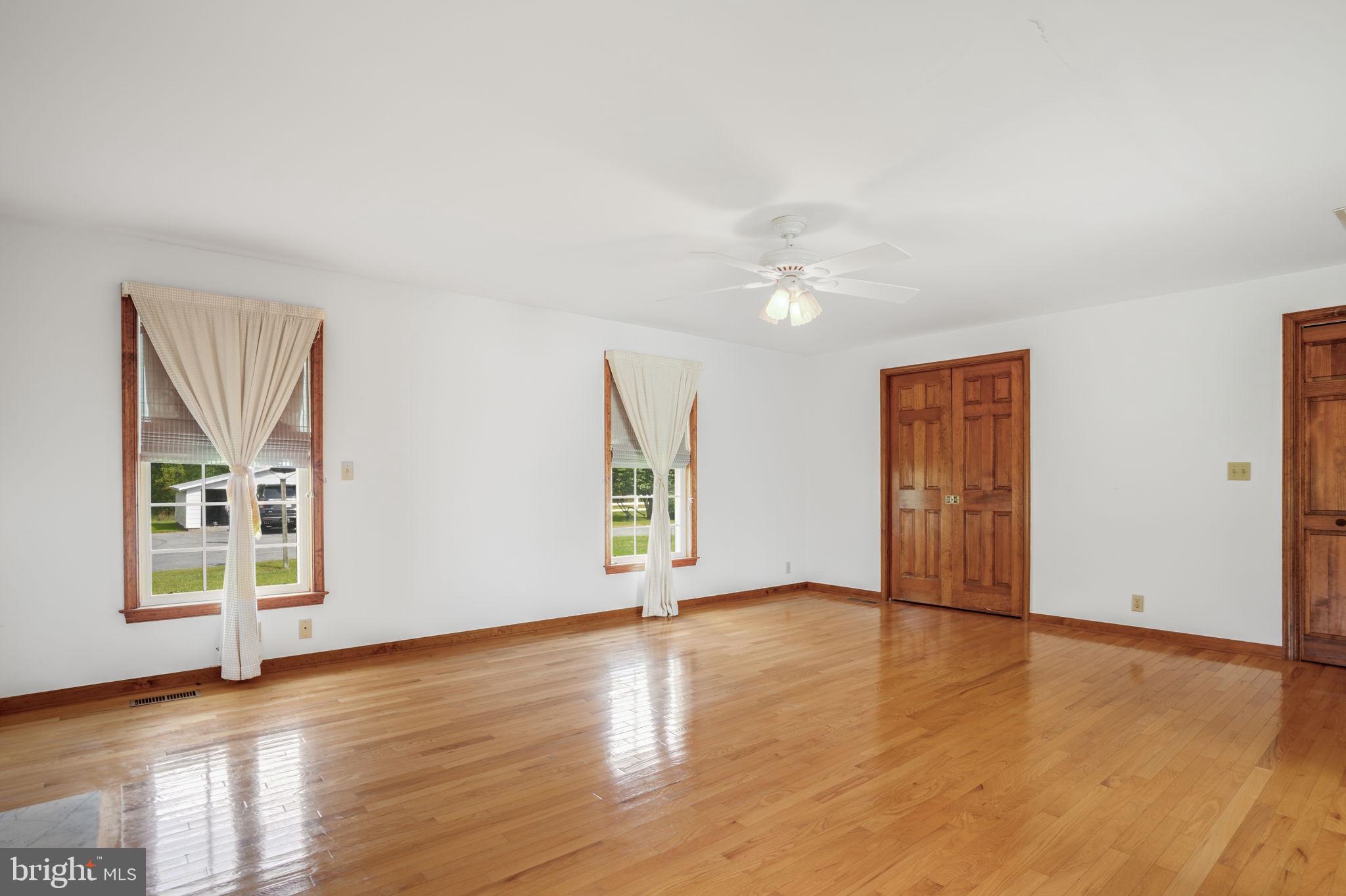 9449 Carey Road Berlin, MD 21811 - Photo 84 of 108 an empty room with wooden floor and windows