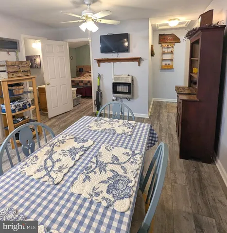 a bedroom with a bed dresser and a flat screen tv