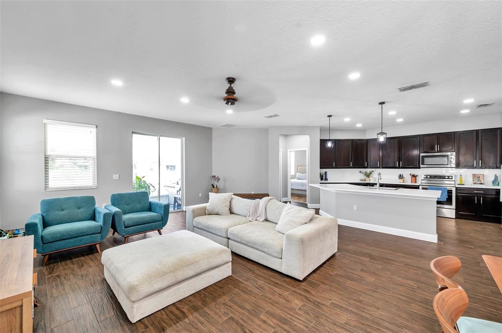 7523 Tangle Brook Boulevard Gibsonton, FL 33534 - Photo 12 of 35 a living room with furniture and view of kitchen
