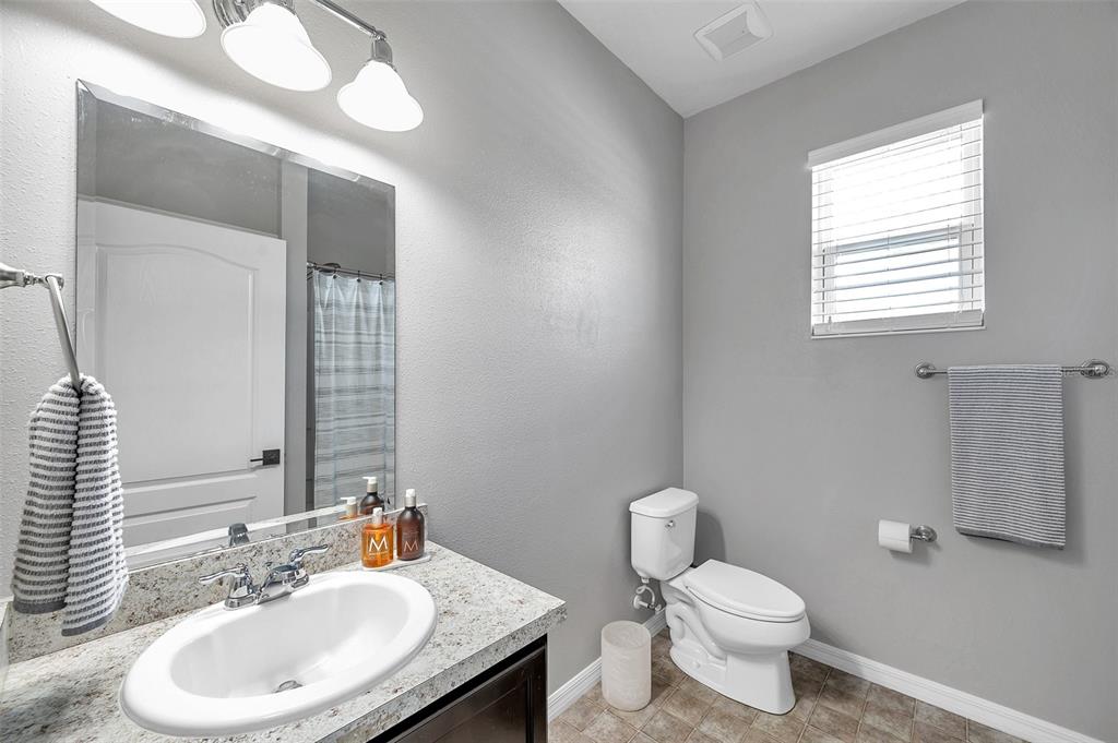 7523 Tangle Brook Boulevard Gibsonton, FL 33534 - Photo 21 of 35 a bathroom with a sink a toilet and mirror