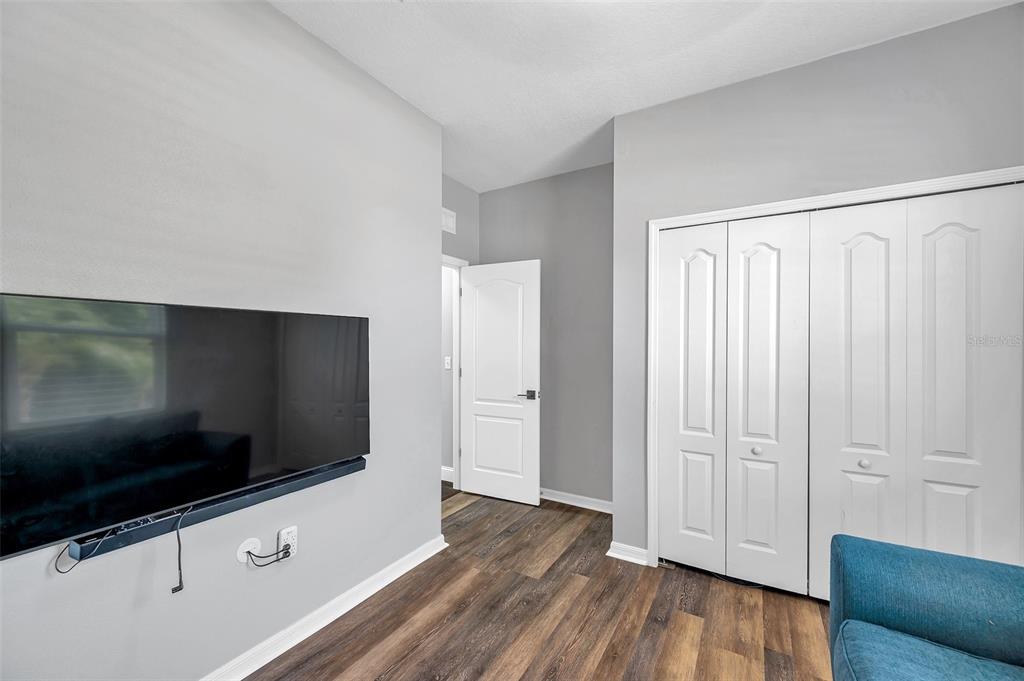 7523 Tangle Brook Boulevard Gibsonton, FL 33534 - Photo 23 of 35 a living room with a flat screen tv and wooden floor