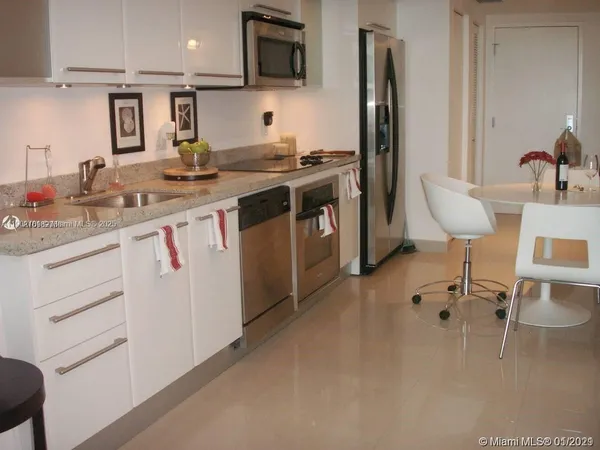 a kitchen with a sink cabinets and stainless steel appliances