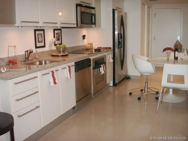 a kitchen with a sink cabinets and stainless steel appliances