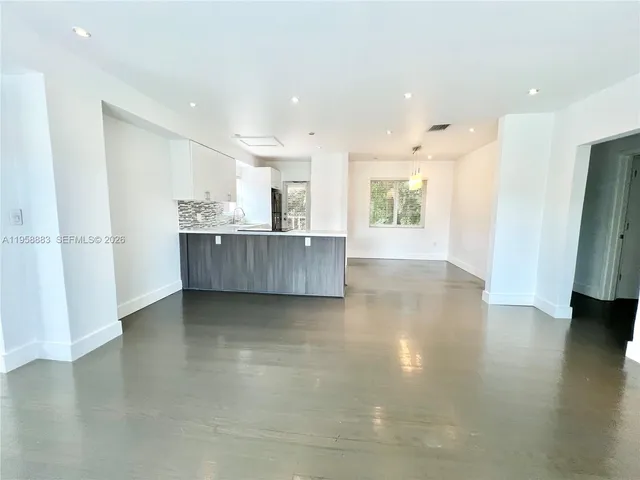 a view of kitchen and hall with wooden floor