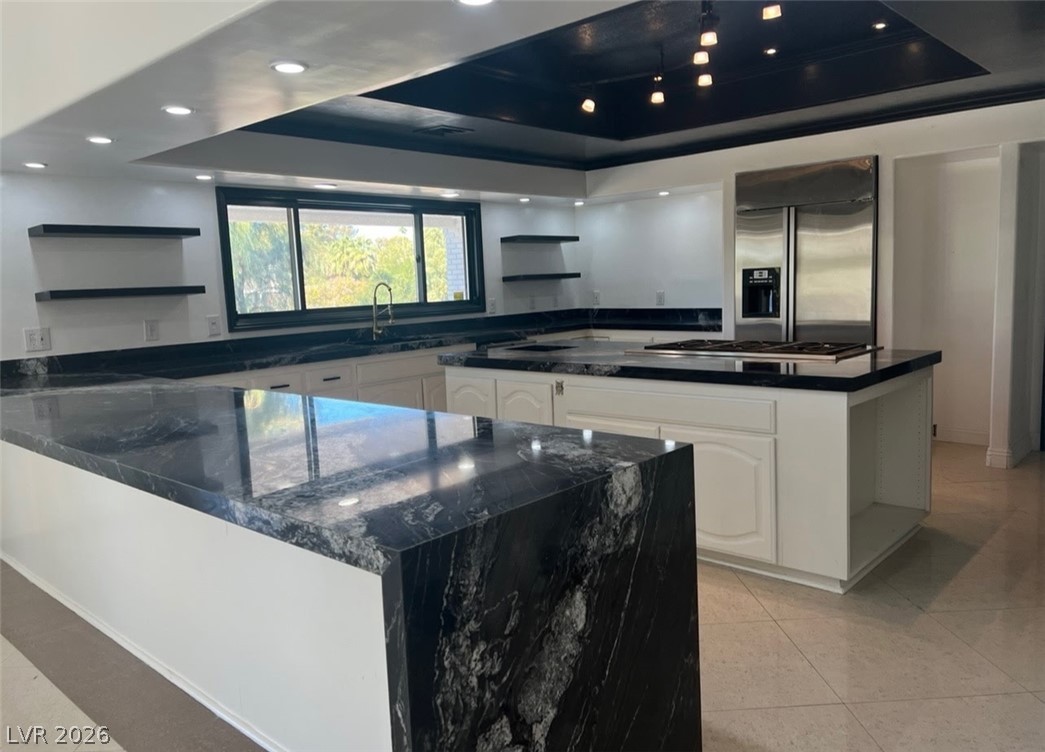 3003 Regency Hill Henderson, NV 89014 - Photo 3 of 13 Granite counters and stainless steel appliances elevate this kitchen's modern aesthetic.