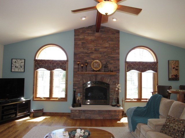 1027 West Kennedy Road Braidwood, IL 60408 - Photo 21 of 55 a living room with furniture a fireplace and a flat screen tv