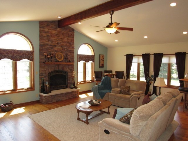 1027 West Kennedy Road Braidwood, IL 60408 - Photo 22 of 55 a living room with furniture a fireplace and a chandelier