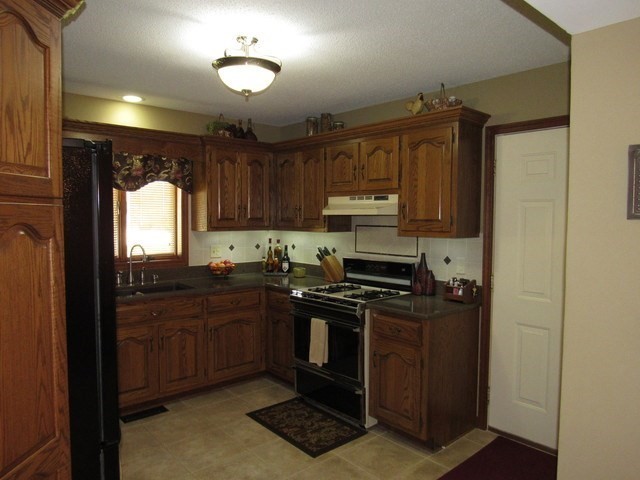 1027 West Kennedy Road Braidwood, IL 60408 - Photo 30 of 55 a kitchen with stainless steel appliances granite countertop a stove a sink and a refrigerator