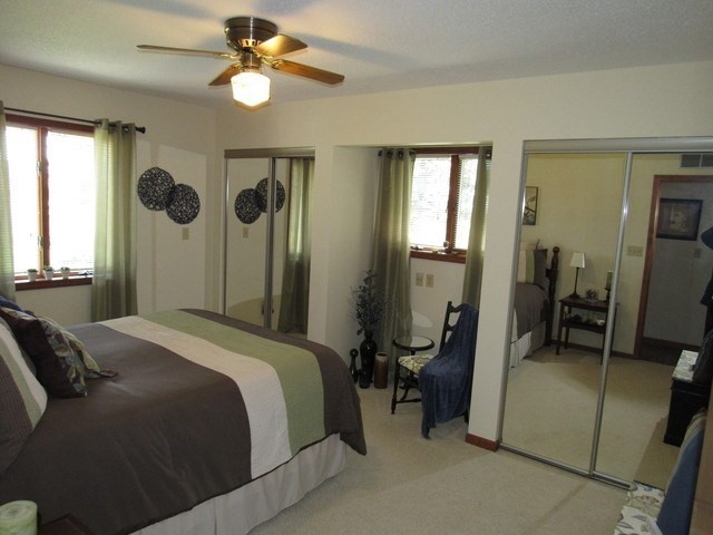 1027 West Kennedy Road Braidwood, IL 60408 - Photo 40 of 55 a bedroom with a bed and a chandelier