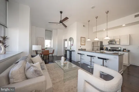 a kitchen with stainless steel appliances kitchen island granite countertop a sink and cabinets