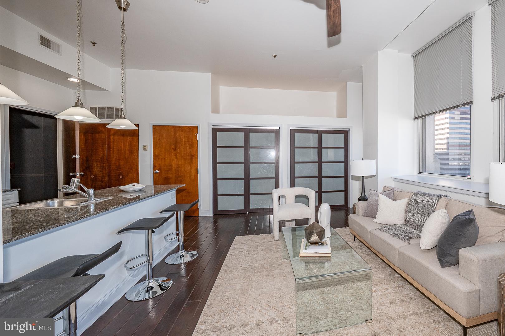 1001 Chestnut Street, Unit 705E Philadelphia, PA 19103 - Photo 22 of 36 a living room with furniture and a large window