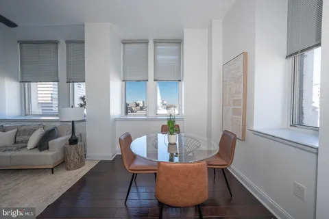 a view of a dining room with furniture and wooden floor