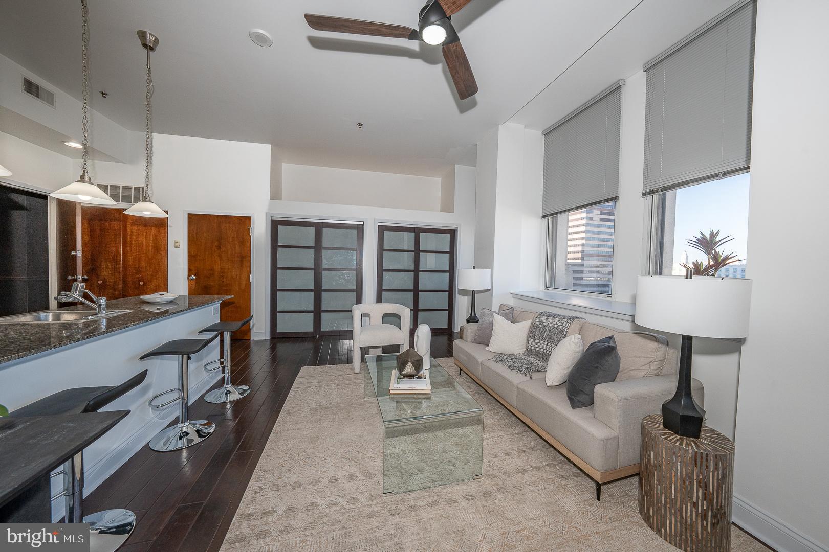 1001 Chestnut Street, Unit 705E Philadelphia, PA 19103 - Photo 24 of 36 a living room with furniture and a large window
