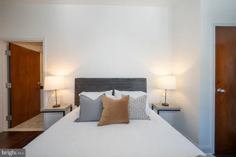 a large bed sitting in a bedroom and lamp