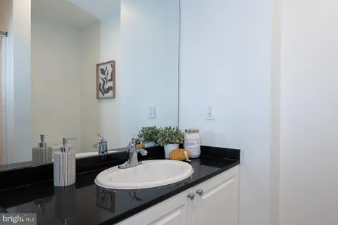 a bathroom with a sink vanity mirror and toilet