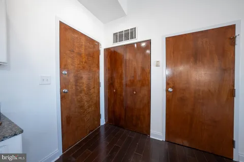 a view of hallway with wooden floor
