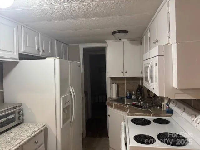 a kitchen with a refrigerator and a sink
