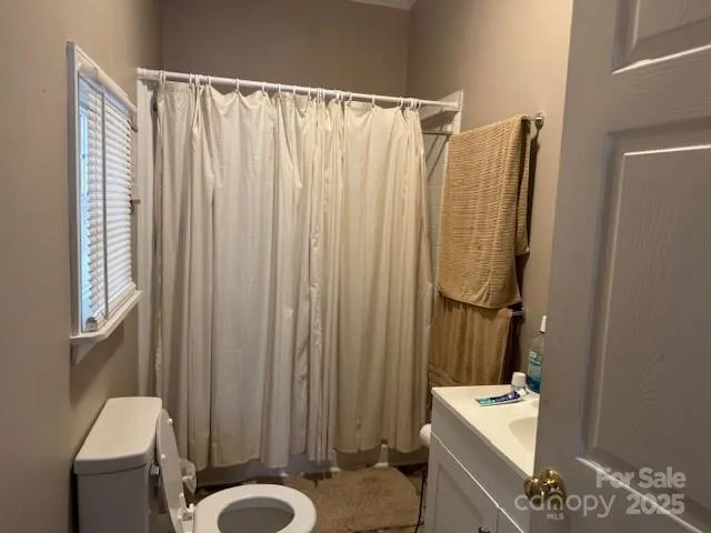 a bathroom with a shower curtain and a sink