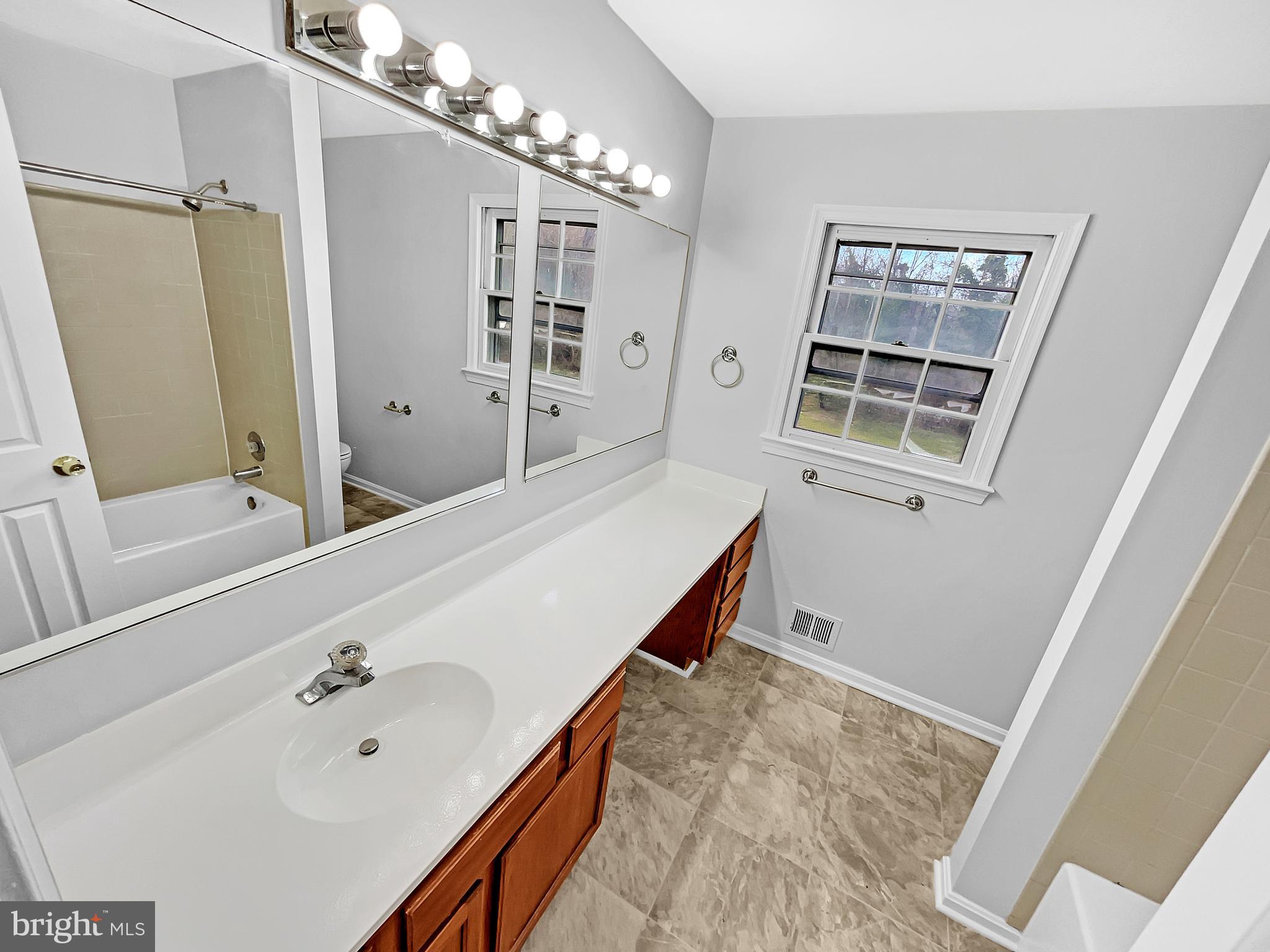 1624 Hiddenbrook Drive Herndon, VA 20170 - Photo 30 of 58 a bathroom with a tub sink and mirror