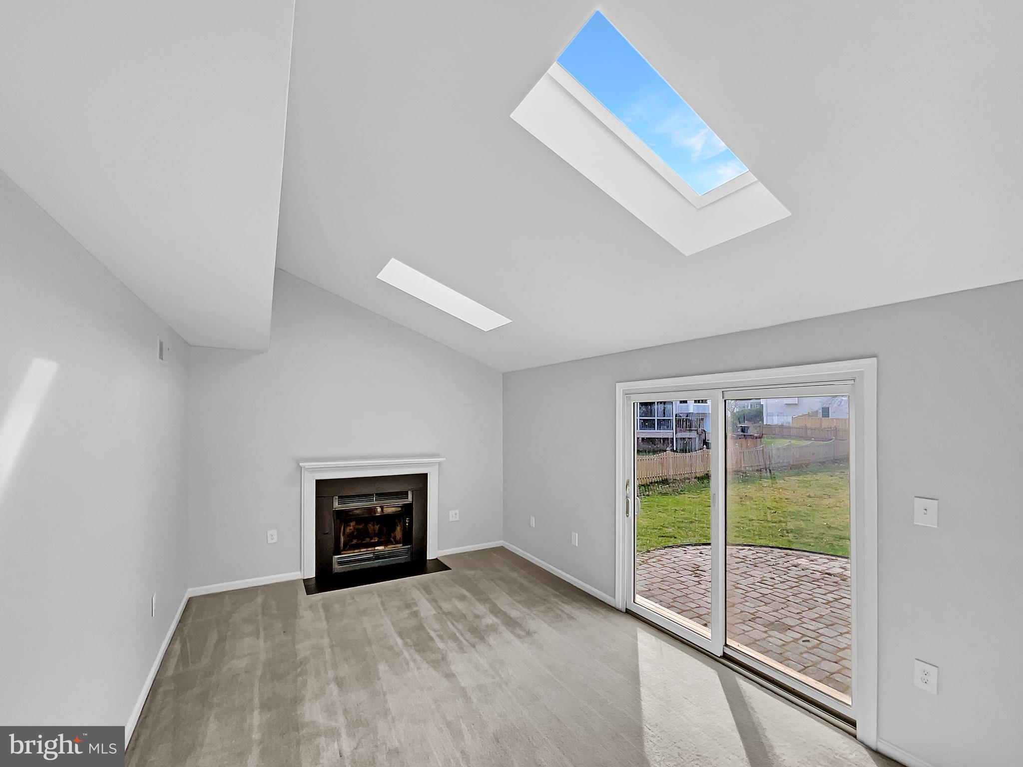 1624 Hiddenbrook Drive Herndon, VA 20170 - Photo 3 of 58 a view of an empty room with a fireplace and a window