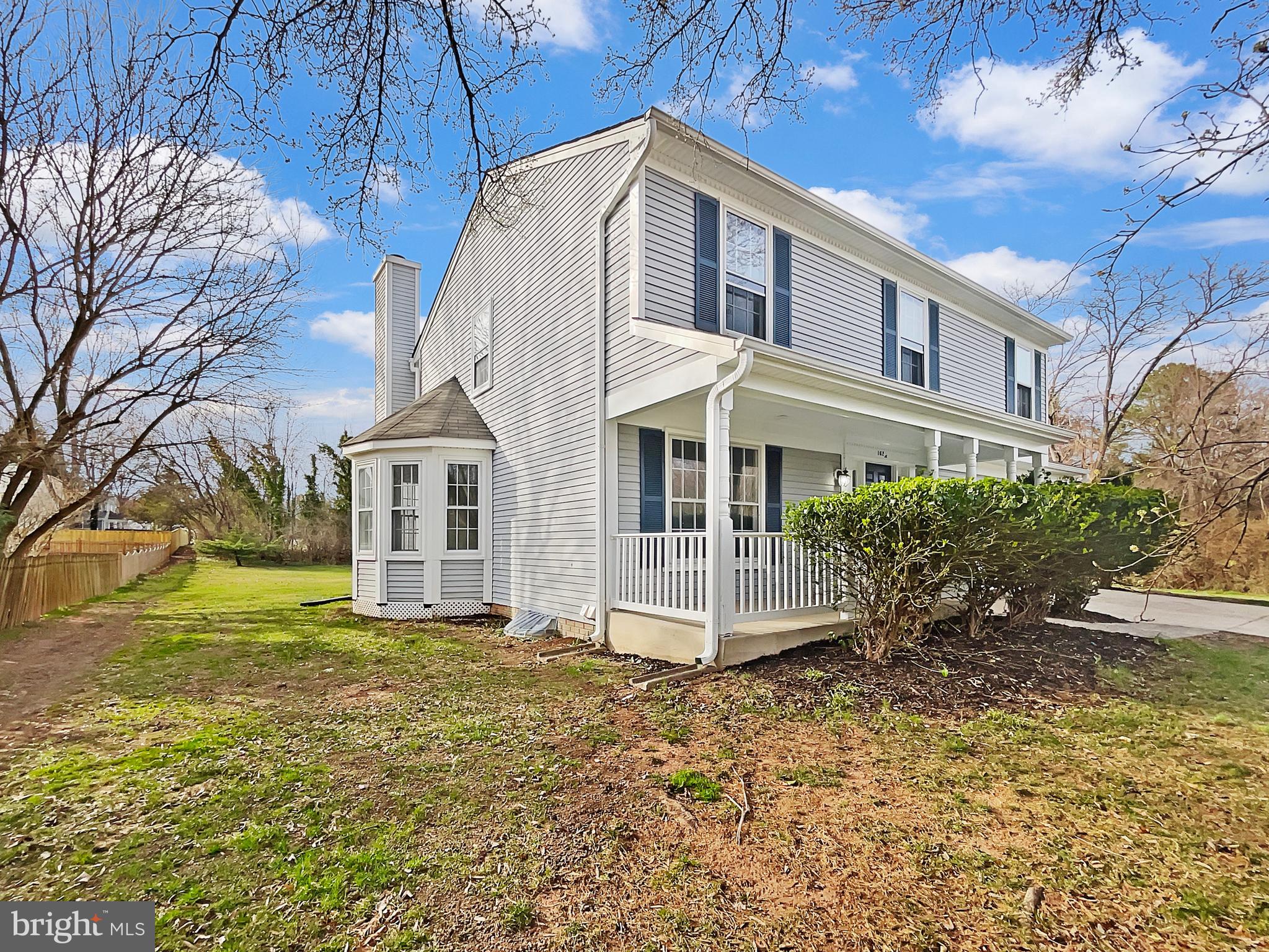 1624 Hiddenbrook Drive Herndon, VA 20170 - Photo 52 of 58 a view of a white house next to a yard with big trees