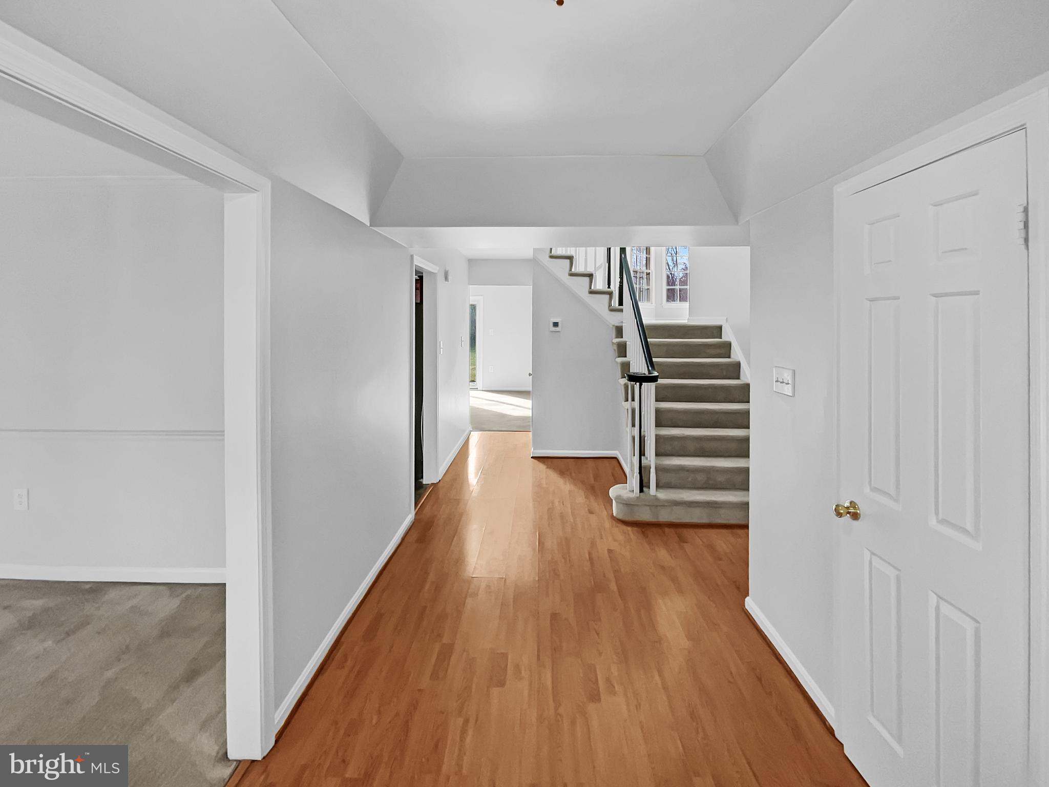 1624 Hiddenbrook Drive Herndon, VA 20170 - Photo 9 of 58 a view of a hallway with wooden floor and stairs