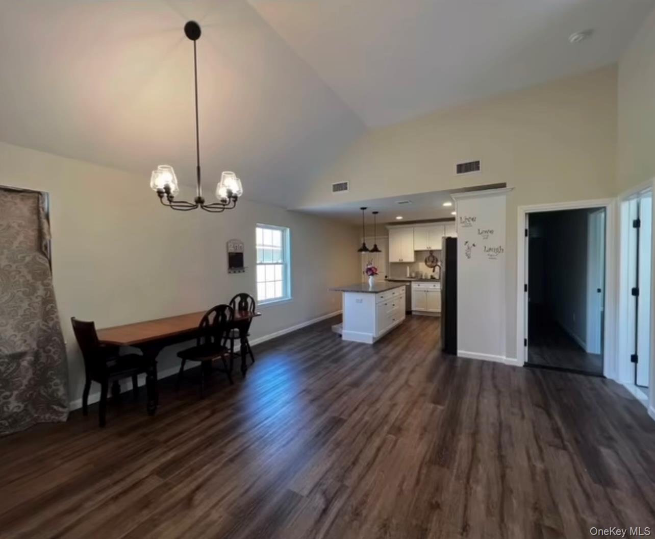 118 Plains Road, Unit 2 Walden, NY 12586 - Photo 2 of 15 a view of a room with wooden floor kitchen table and chairs