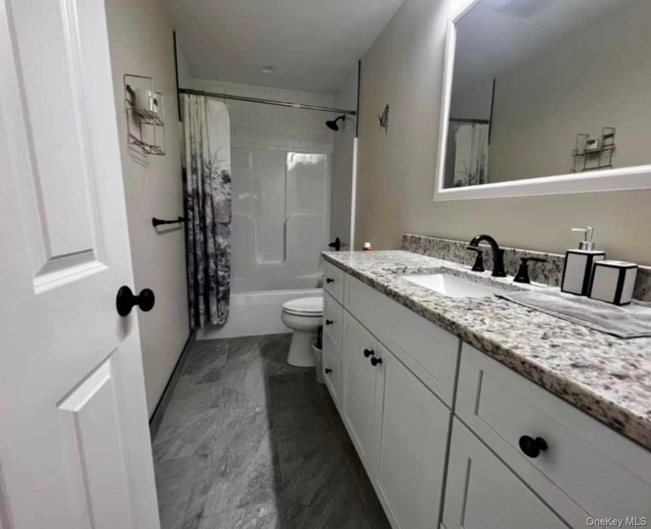 118 Plains Road, Unit 2 Walden, NY 12586 - Photo 9 of 15 a bathroom with a double vanity sink toilet mirror and shower