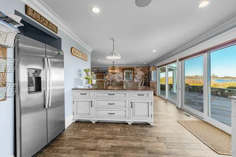 a kitchen with stainless steel appliances kitchen island granite countertop a refrigerator and a stove