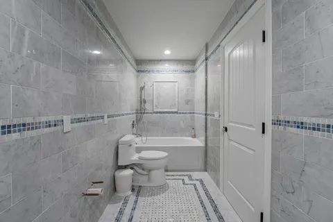 a bathroom with a toilet a sink and a shower