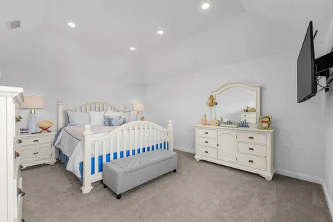 a bedroom with a bed and a dresser