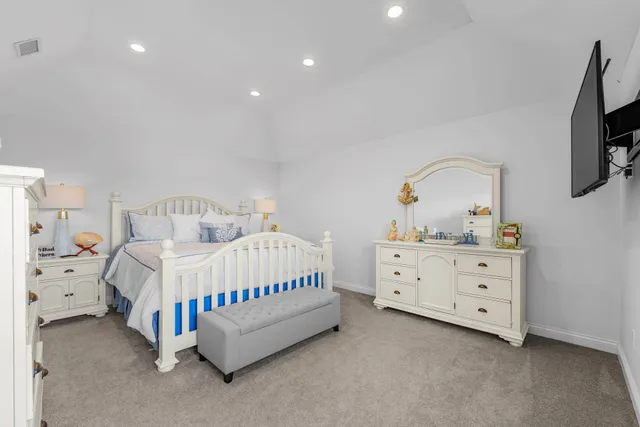 a bedroom with a bed and a dresser