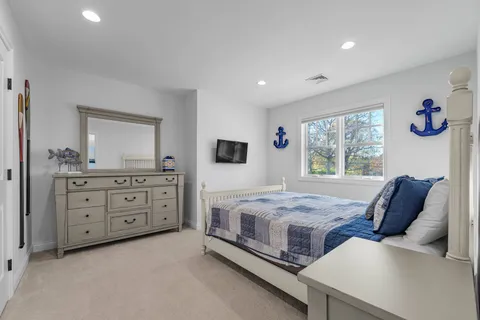 a bedroom with a bed and a dresser