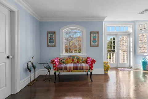 a living room with furniture and a floor to ceiling window