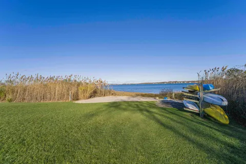 a view of a lake with houses in the back