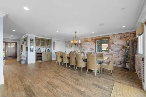 a view of a dining room with furniture and chandelier