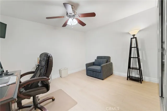 a view of a livingroom with workspace and a window